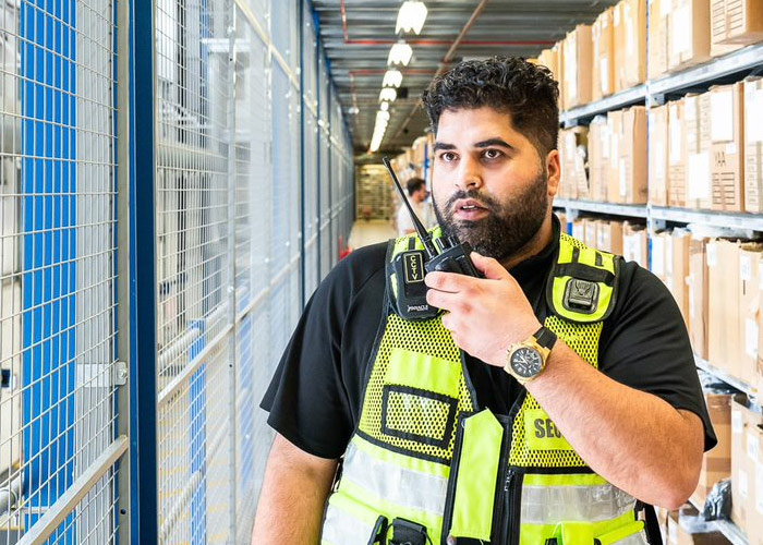 Security officer patrolling in a warehouse environment